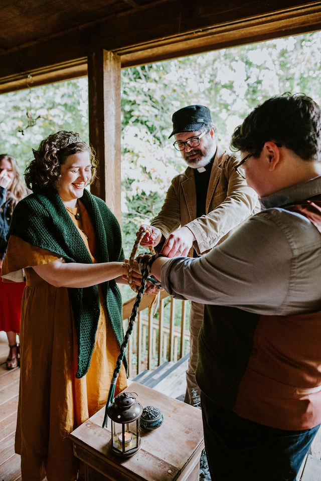 Wedding couple during a handfasting ceremony. 
