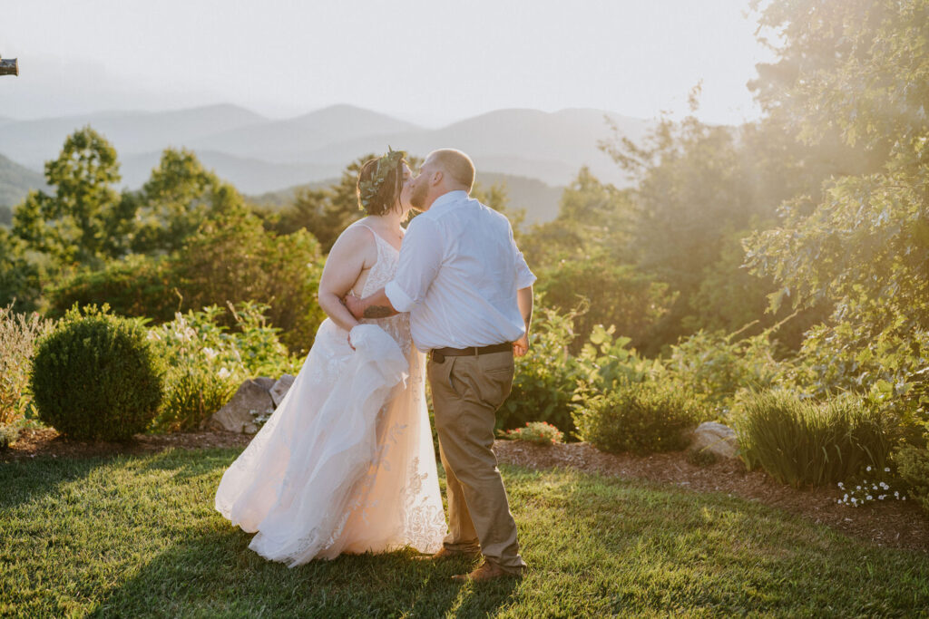 A wedding couple kissing at sunset.