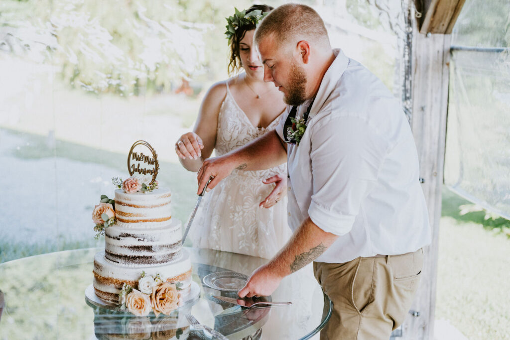 A married couple cutting their wedding cake. 