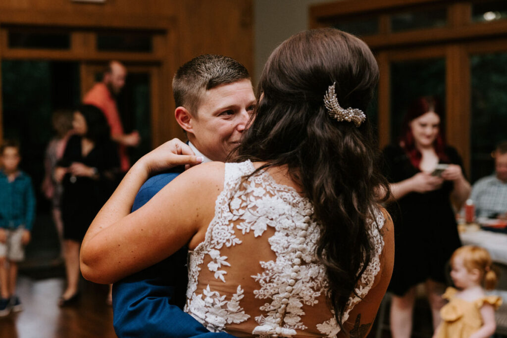 A close up of a newlywed couple during their first dance at their reception. 
