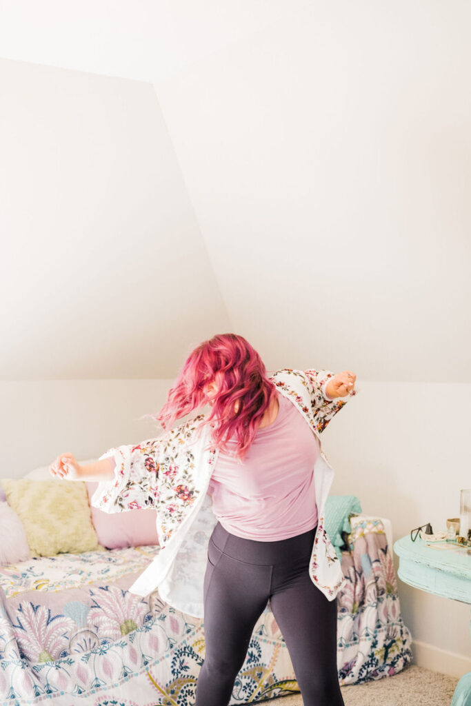 A person dancing in a bedroom 