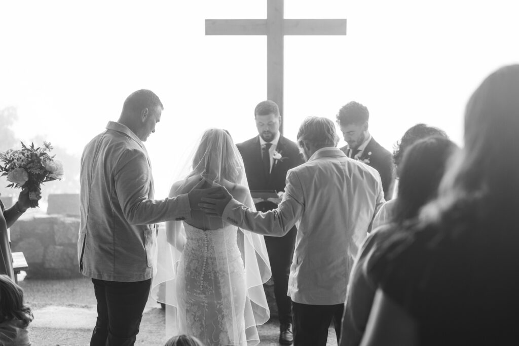 A couple stands up at the altar.