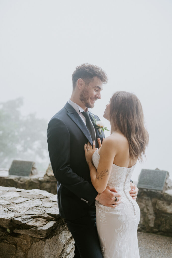 A couple looks into each other's eyes, smiling.