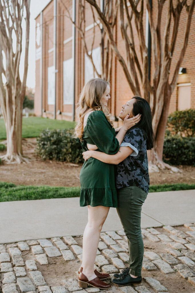 A couple with their arms around each other as they are about to kiss 