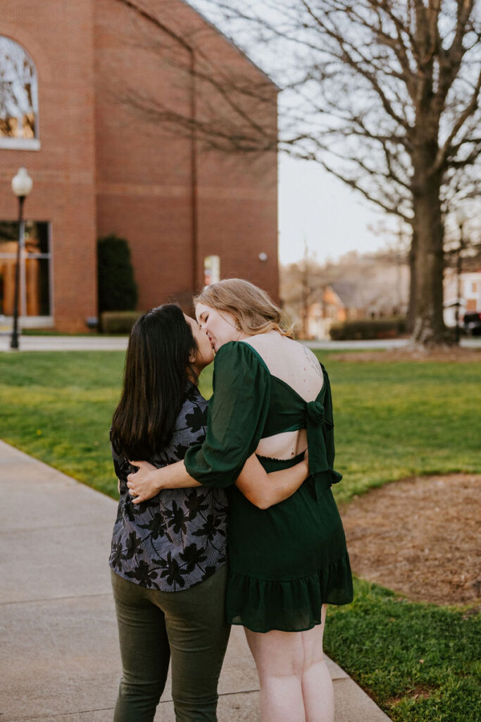 A couple kissing with their arms around each other. 