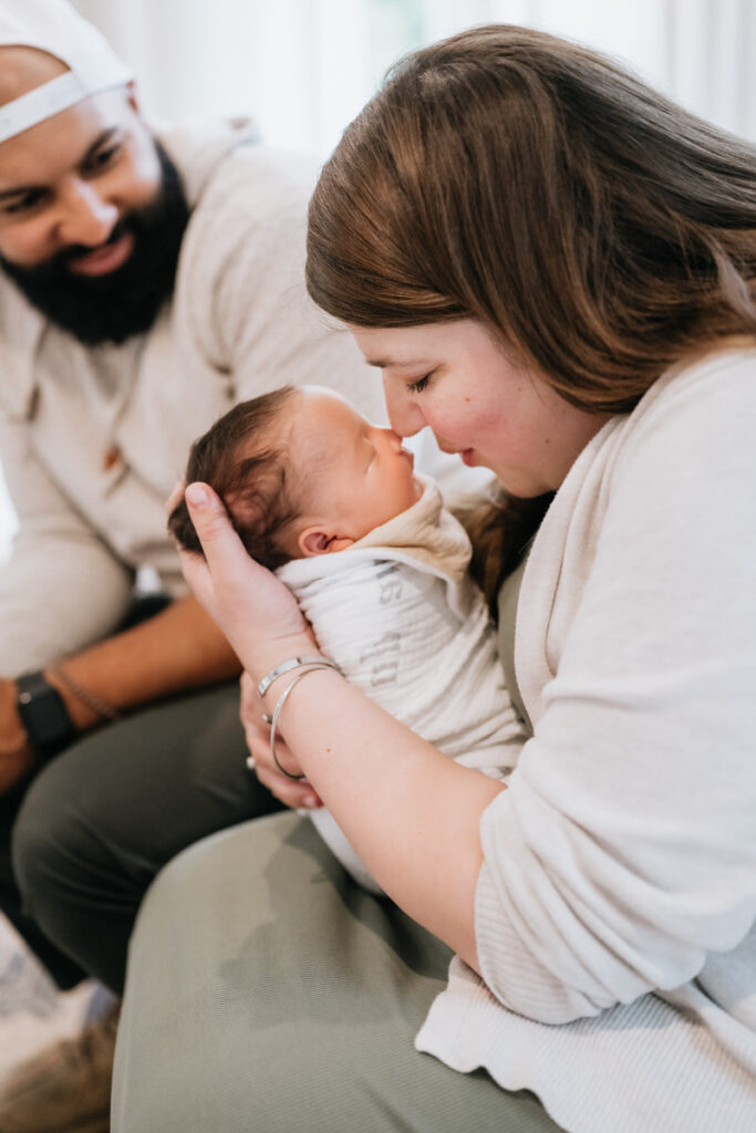 A parent nose to nose with their newborn 